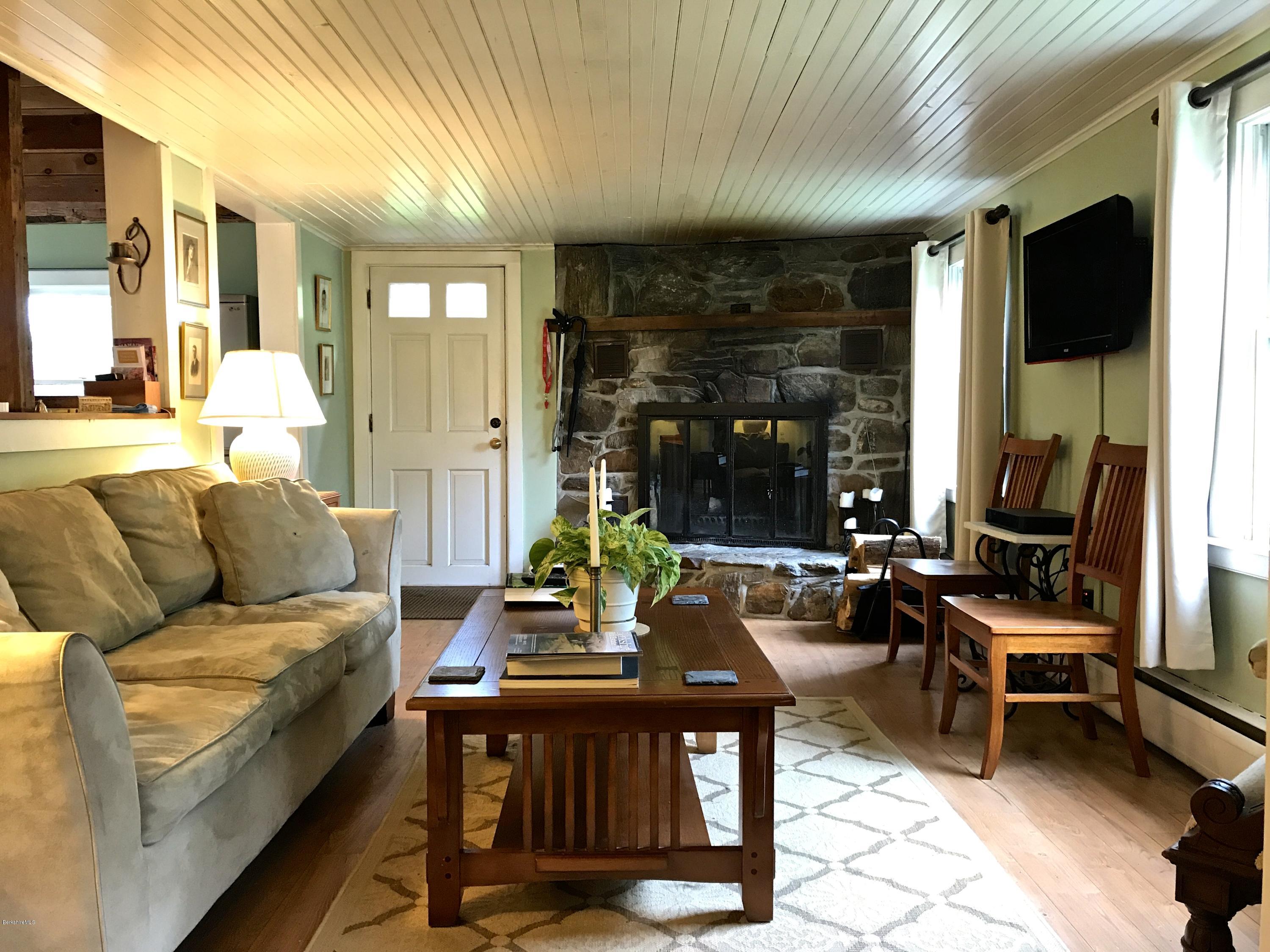 59 Salisbury Road Sheffield, MA 01257 - Photo 23 of 45 a living room with furniture a large window and a flat screen tv