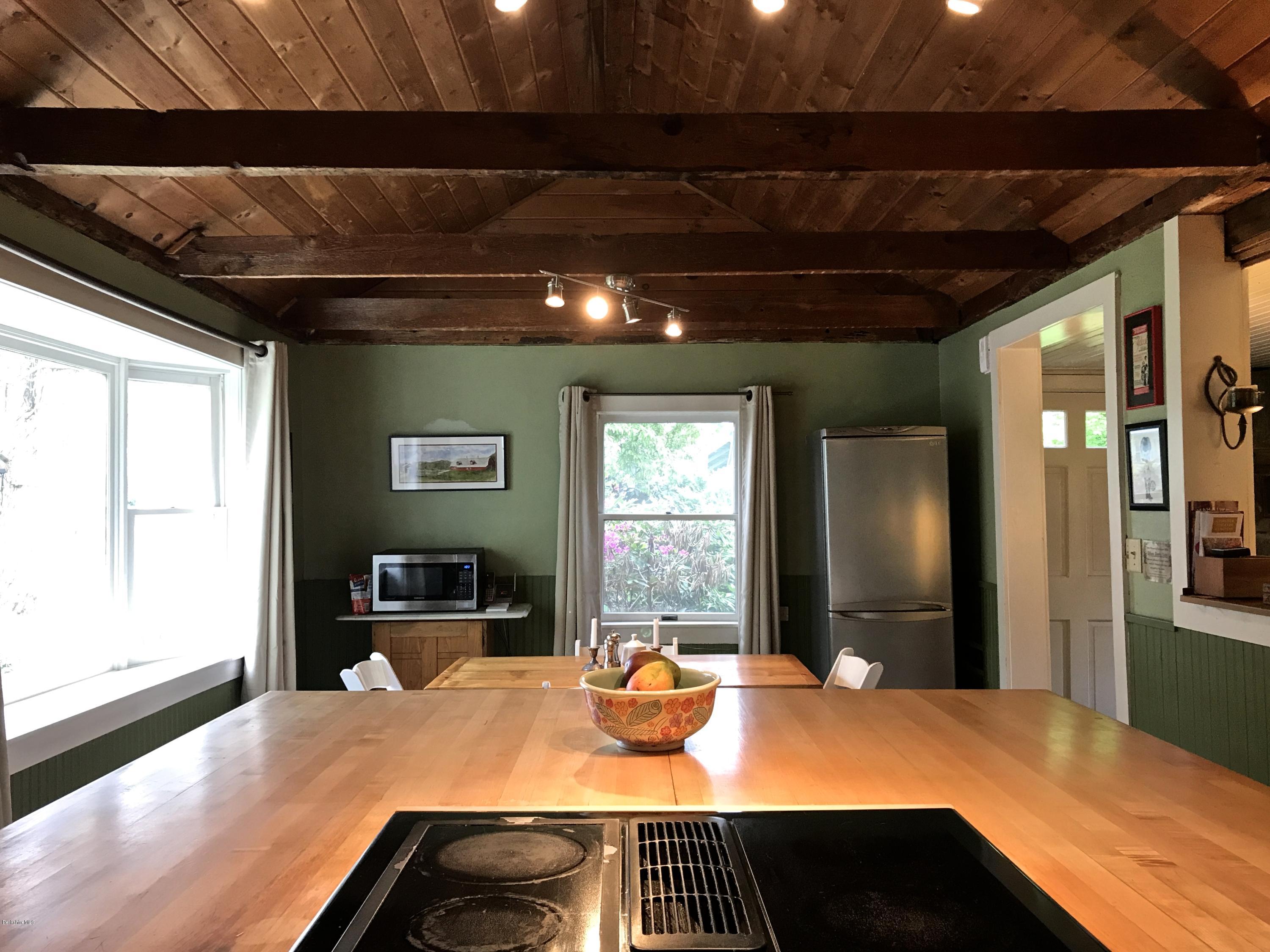 59 Salisbury Road Sheffield, MA 01257 - Photo 25 of 45 a bedroom with a bed and wooden floor