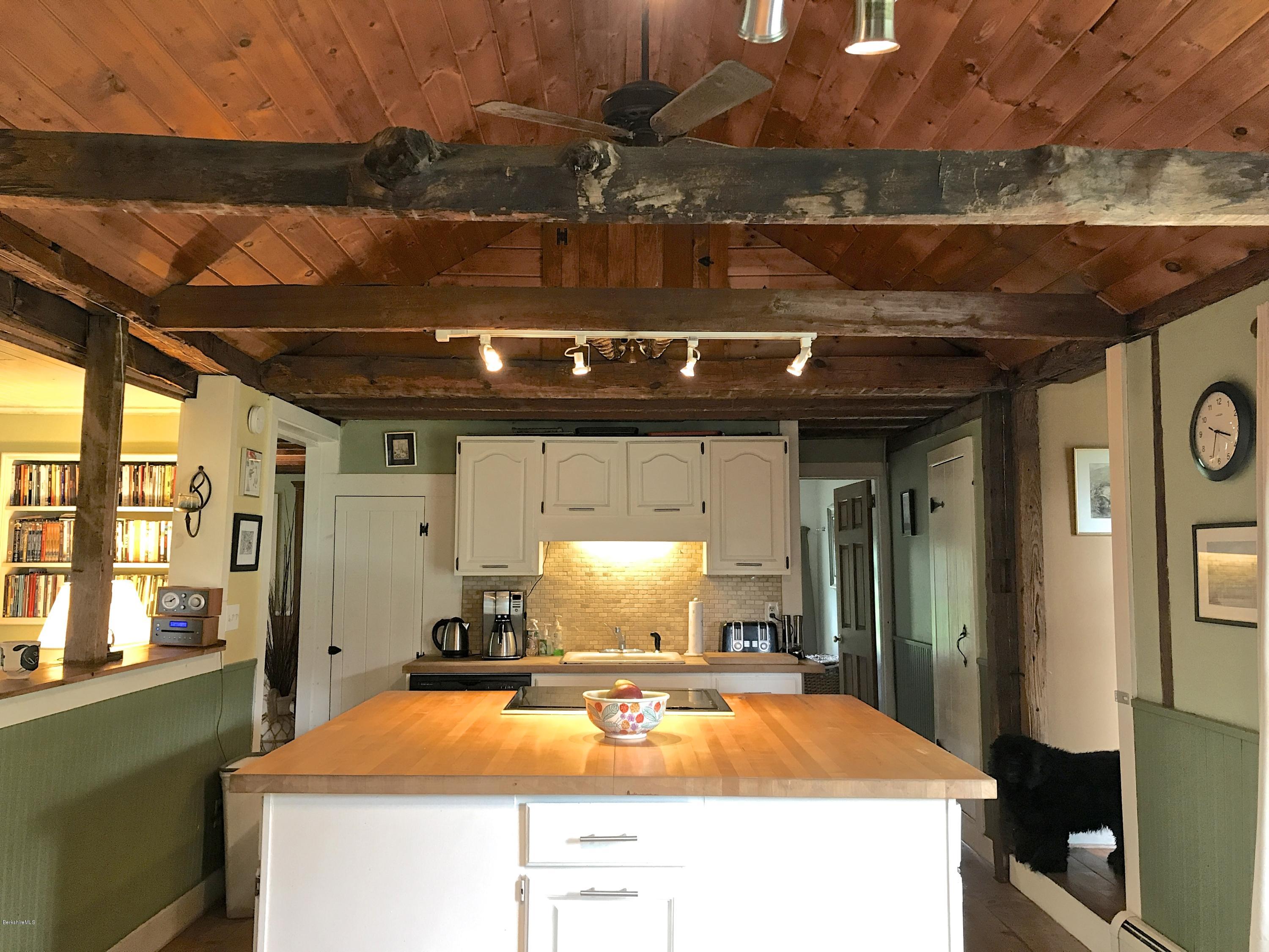 59 Salisbury Road Sheffield, MA 01257 - Photo 27 of 45 a room with stainless steel appliances a dining table and chairs with wooden floor