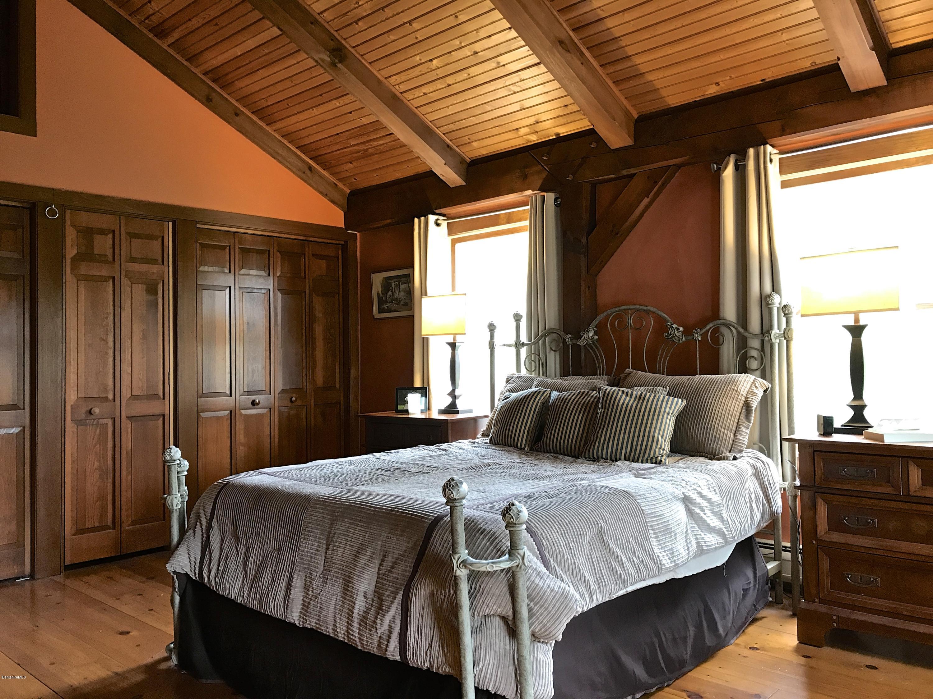 59 Salisbury Road Sheffield, MA 01257 - Photo 35 of 45 a bedroom with a bed and wooden floor