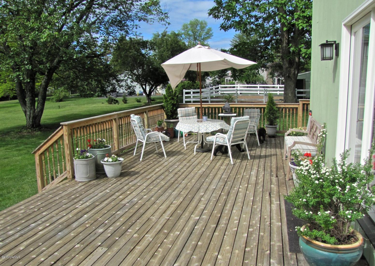 59 Salisbury Road Sheffield, MA 01257 - Photo 6 of 45 a view of a chairs and table on the wooden deck