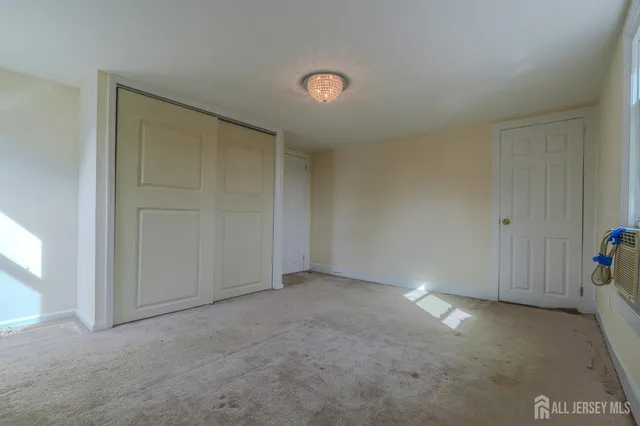 an empty room with closet area