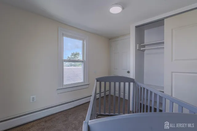 a view of a bedroom with furniture and windows