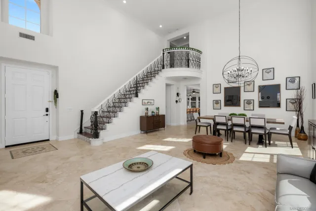 a living room with furniture and view of kitchen