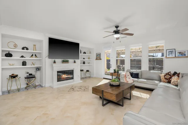 a living room with furniture fireplace and flat screen tv
