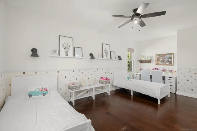 a bedroom with furniture and wooden floor