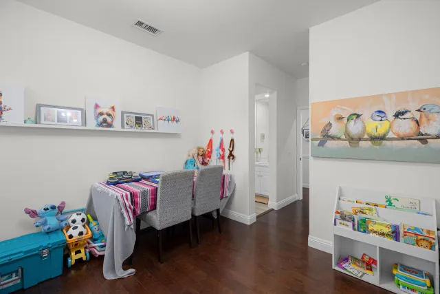 a bedroom with toys and a wooden floor