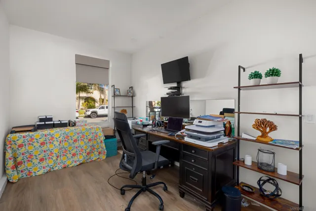 a view of a workspace with furniture and a flat screen tv