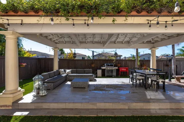 a view of a patio with table and chairs potted plants with wooden floor
