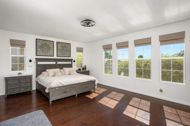 a bedroom with a bed lamp closet and large window
