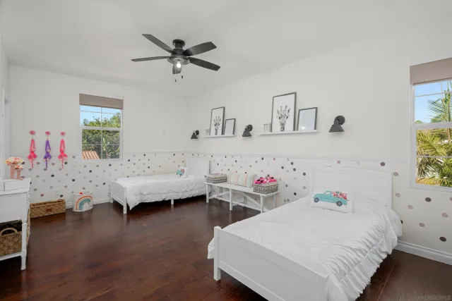 a bedroom with furniture and a wooden floor