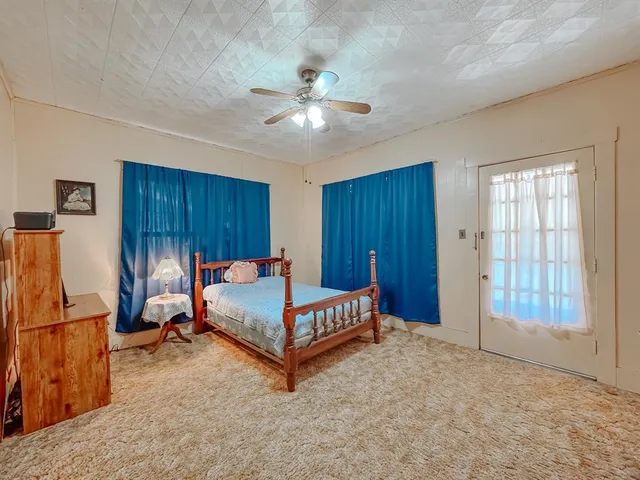 a bedroom with furniture and wooden floor