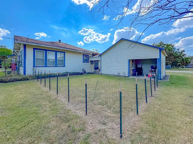 a view of a house with a backyard porch and garden