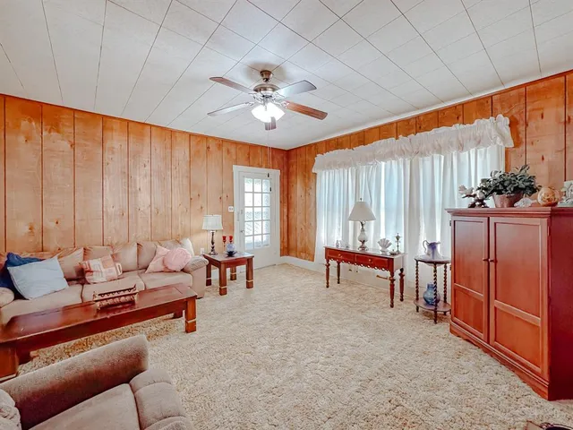 a view of a dining room with furniture and chandelier