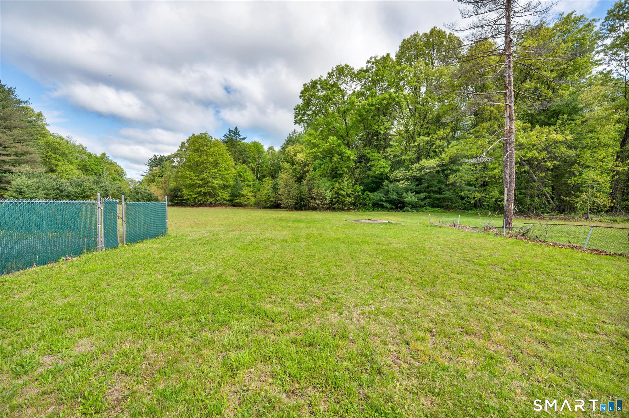 740 Rainbow Road Windsor, CT 06095 - Photo 6 of 40 a view of a field of grass and trees