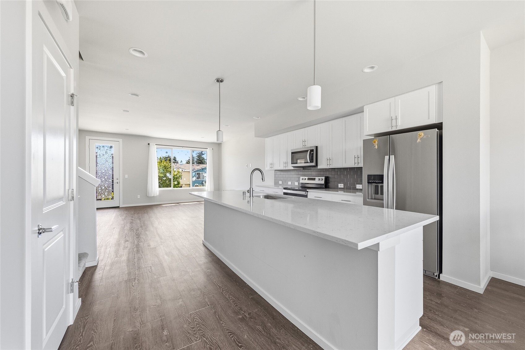 1066 Southwest 99th Place, Unit 55 Seattle, WA 98106 - Photo 7 of 21 a kitchen with stainless steel appliances a refrigerator sink and microwave