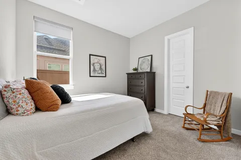 a bedroom with a bed and a dresser