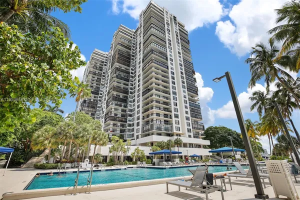 a view of a tall building with a yard