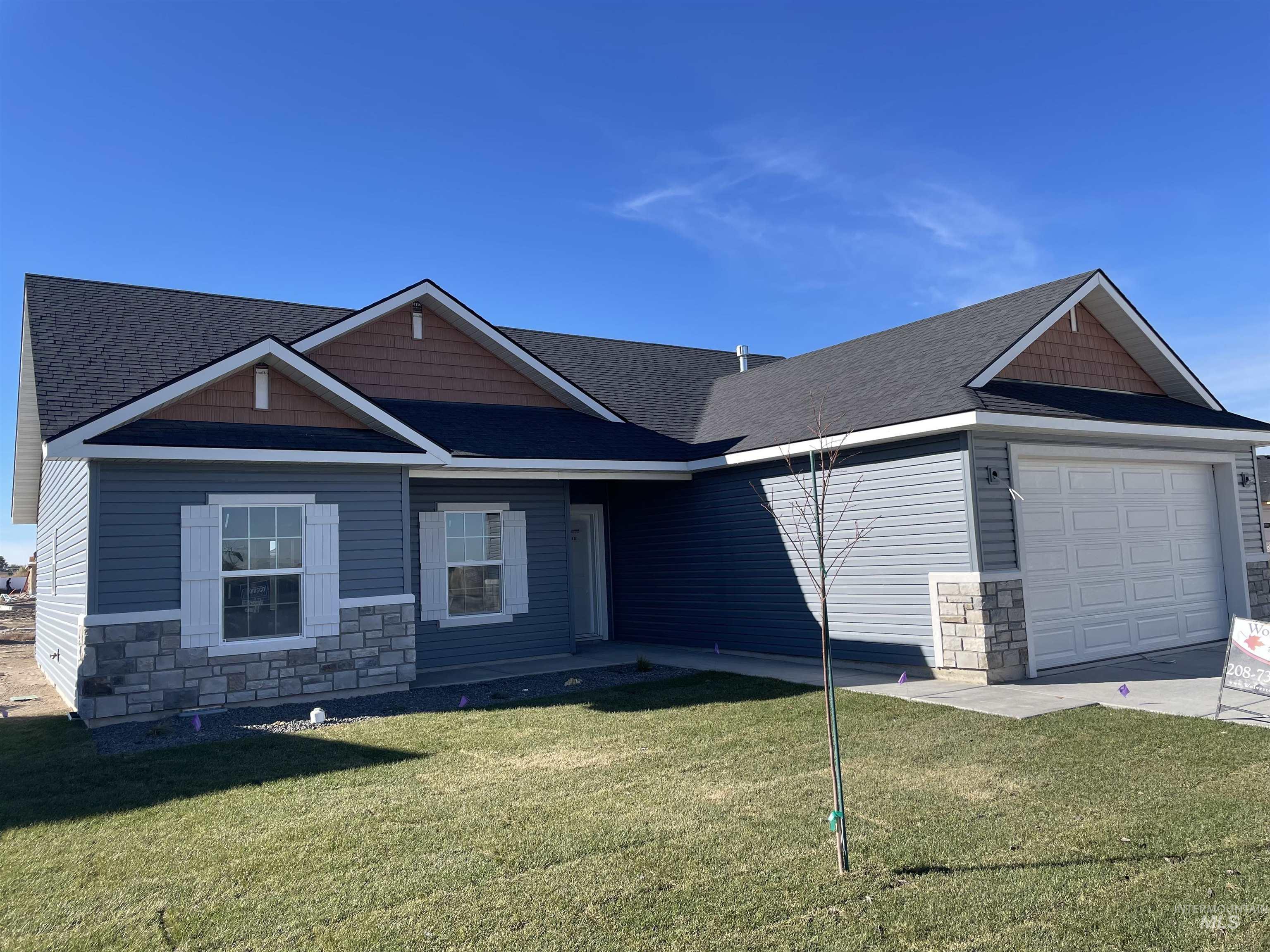 2050 Harrison Street South Twin Falls, ID 83301 - Photo 1 of 1 Craftsman inspired home with stone siding, a garage, a front yard, and roof with shingles