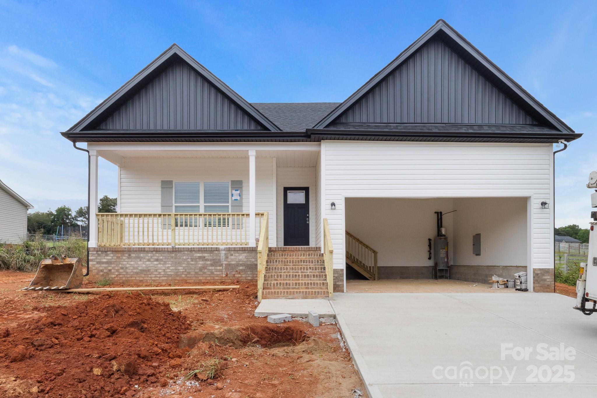 2508 Rock Dam Road Harmony, NC 28634 - Photo 1 of 32 a front view of a house with a yard and garage