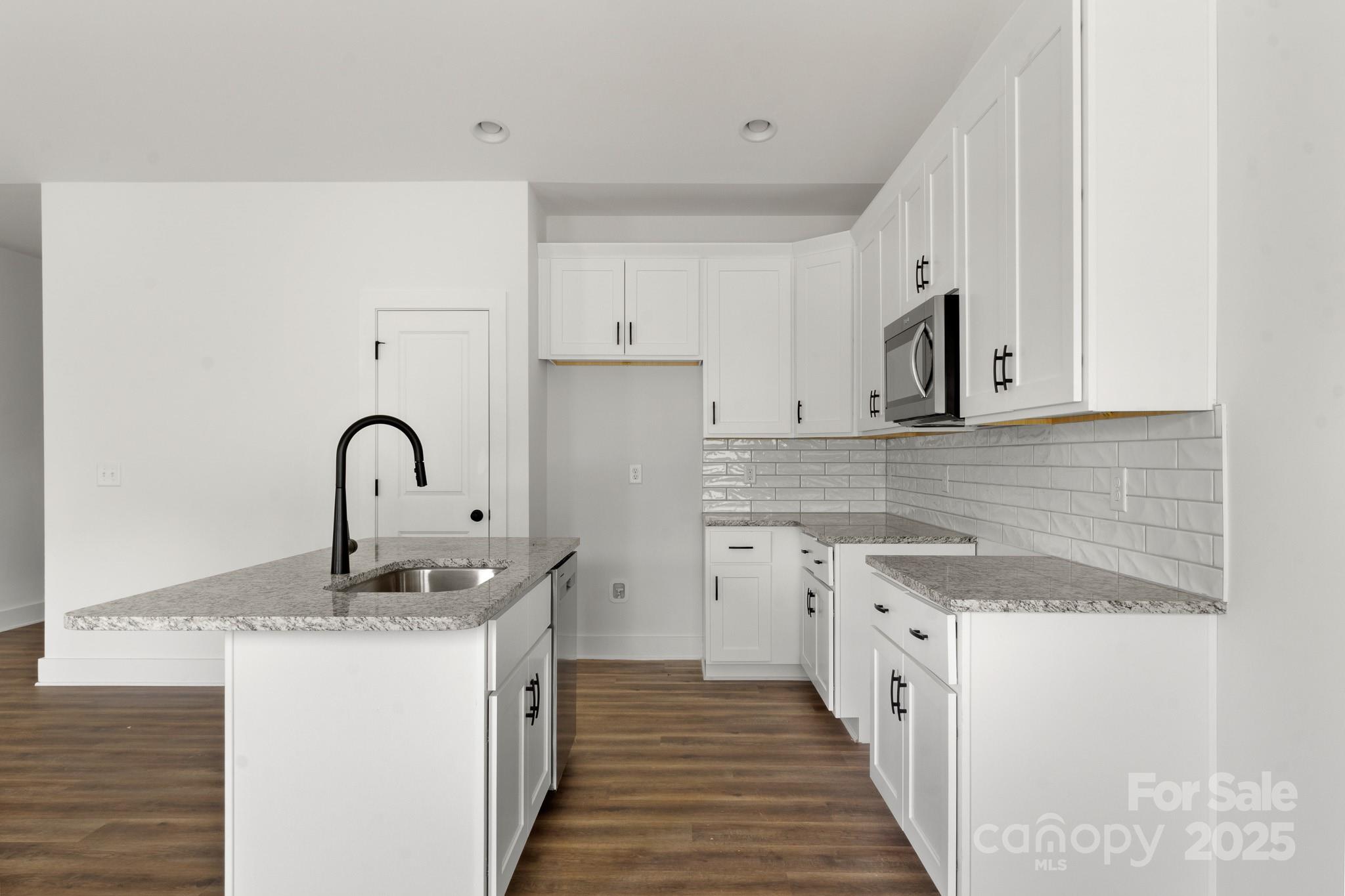 2508 Rock Dam Road Harmony, NC 28634 - Photo 11 of 32 a kitchen with granite countertop a sink and cabinets
