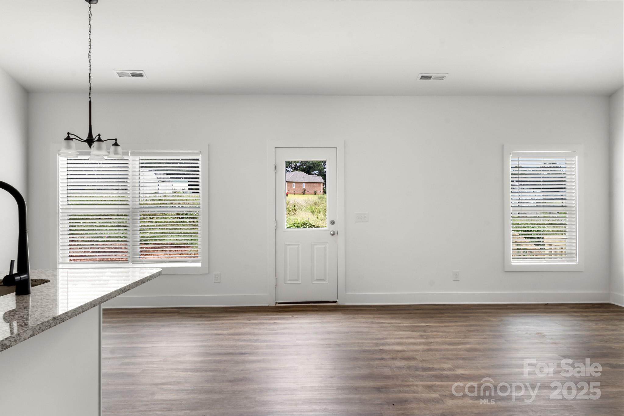 2508 Rock Dam Road Harmony, NC 28634 - Photo 13 of 32 a view of an empty room with window and wooden floor