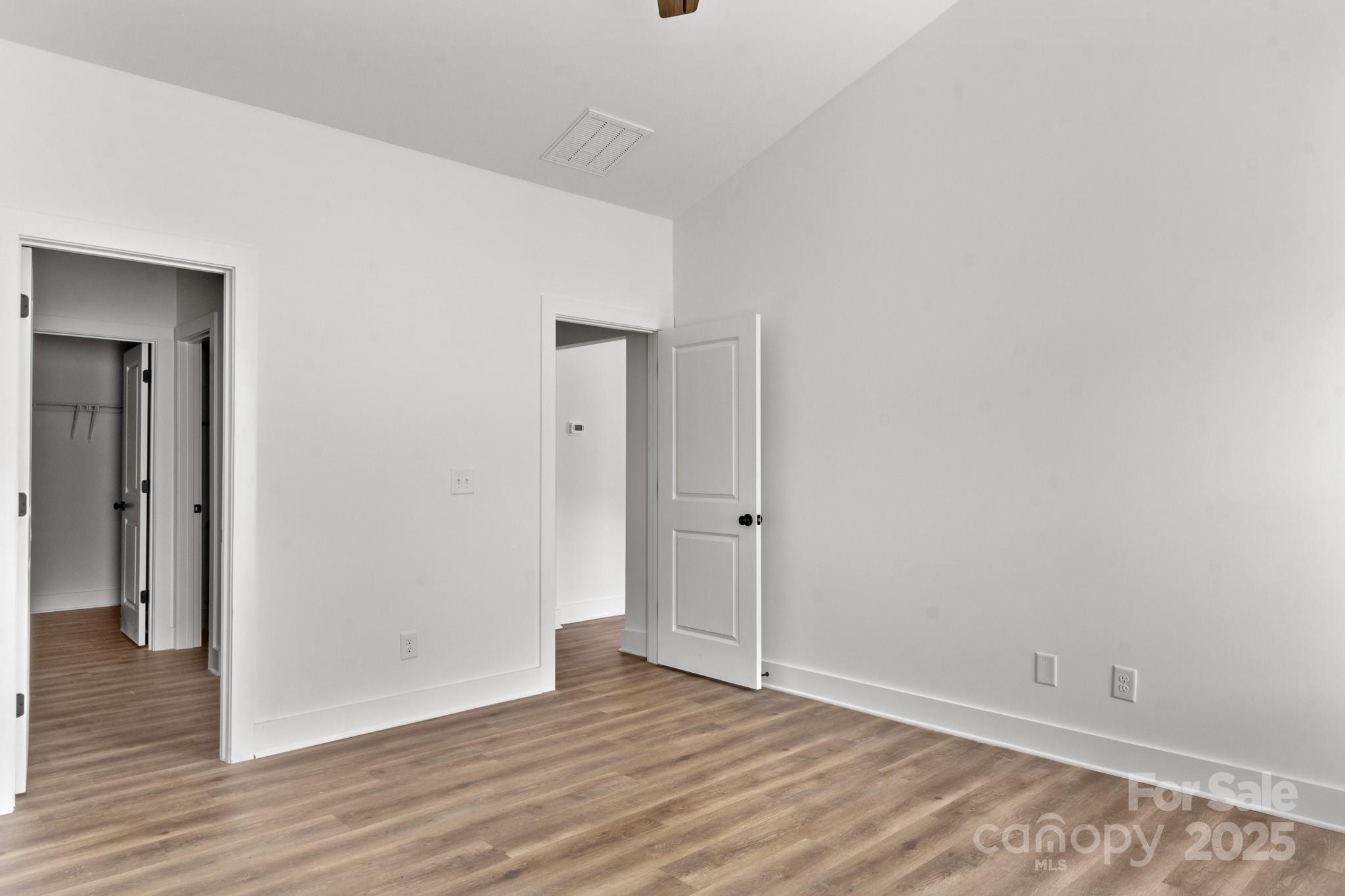 2508 Rock Dam Road Harmony, NC 28634 - Photo 17 of 32 a view of an empty room with wooden floor and closet