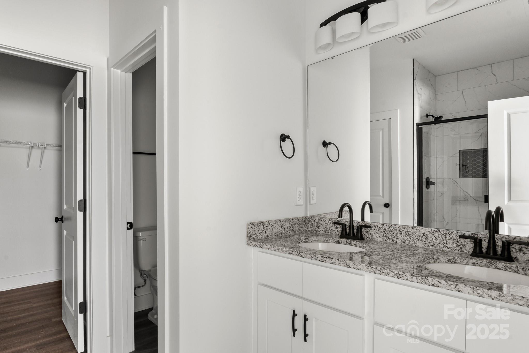 2508 Rock Dam Road Harmony, NC 28634 - Photo 18 of 32 a bathroom with a granite countertop sink and a mirror