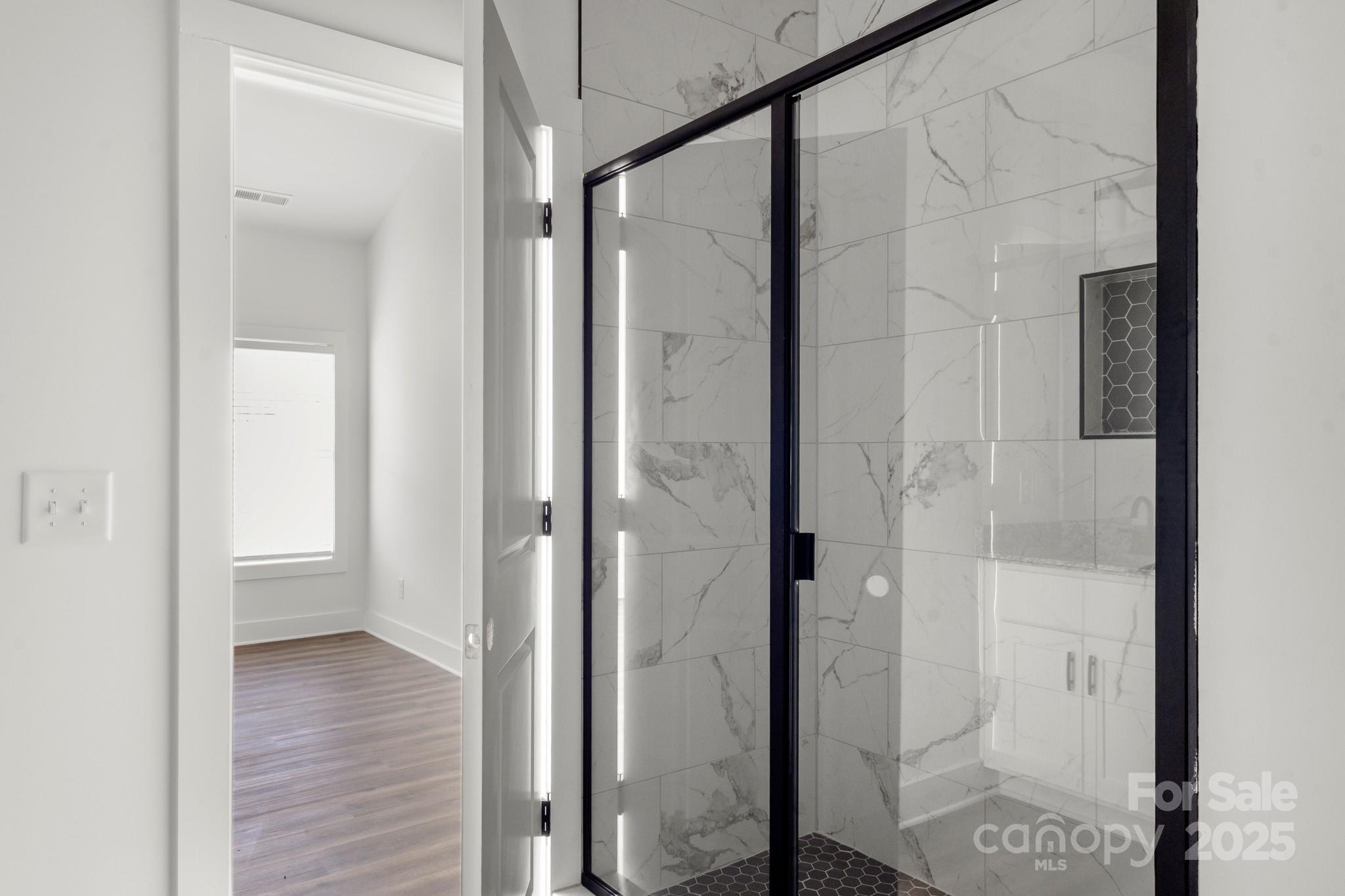2508 Rock Dam Road Harmony, NC 28634 - Photo 19 of 32 a bathroom with a glass shower door