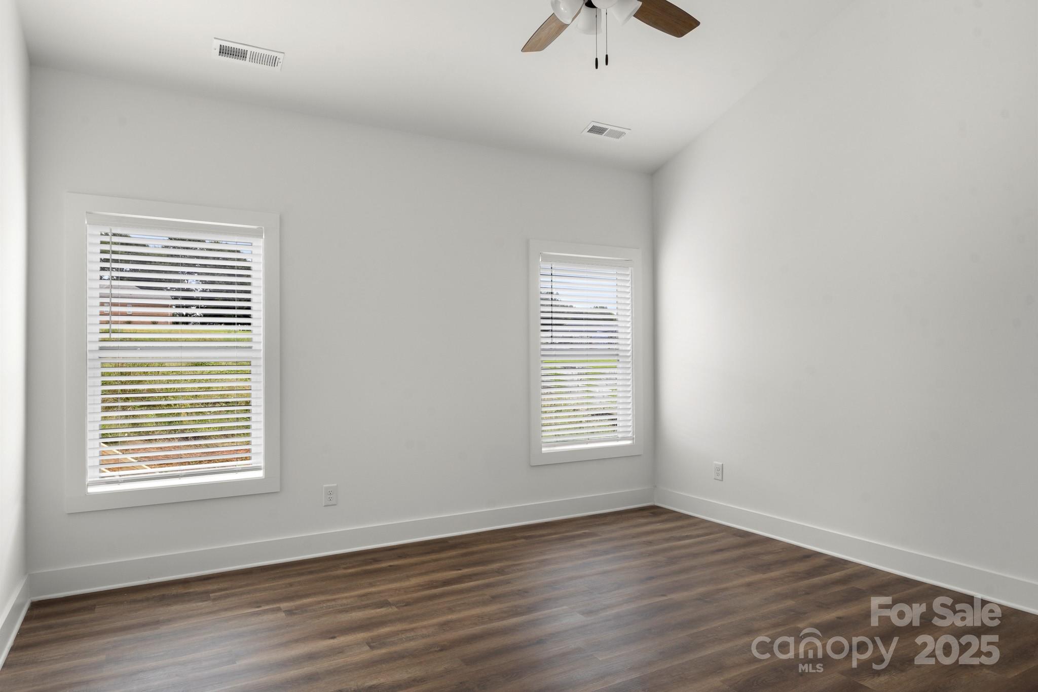 2508 Rock Dam Road Harmony, NC 28634 - Photo 22 of 32 an empty room with wooden floor and windows