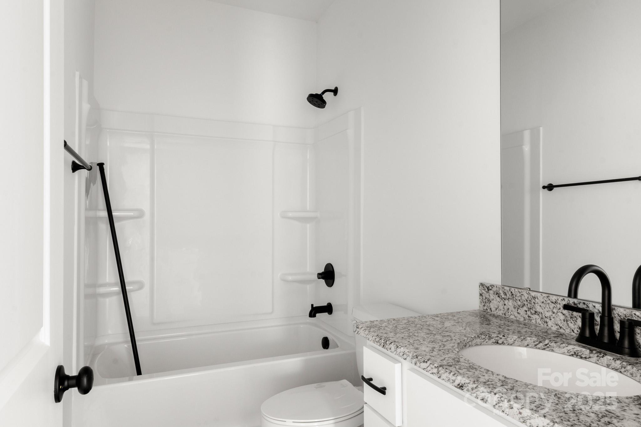 2508 Rock Dam Road Harmony, NC 28634 - Photo 24 of 32 a bathroom with a granite countertop sink toilet and shower