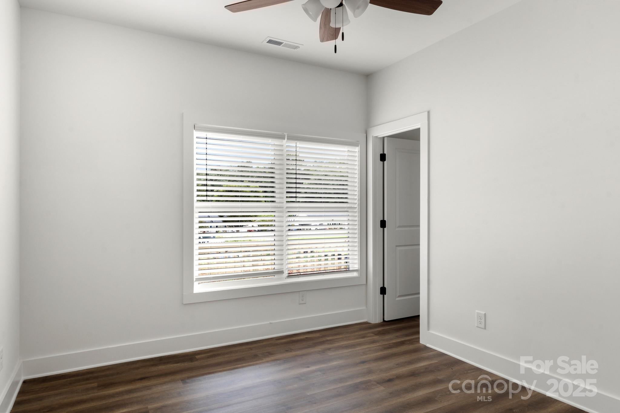 2508 Rock Dam Road Harmony, NC 28634 - Photo 27 of 32 an empty room with wooden floor and windows