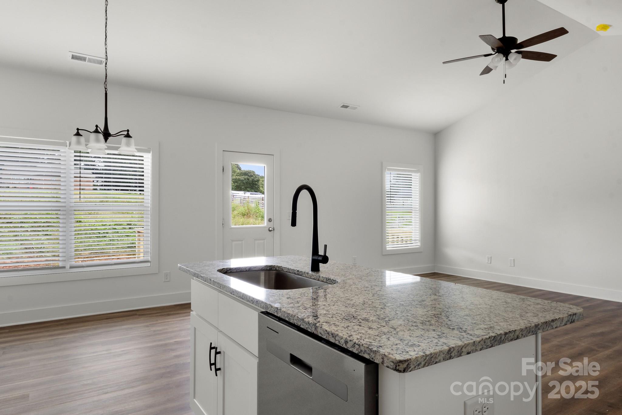 2508 Rock Dam Road Harmony, NC 28634 - Photo 9 of 32 a kitchen with a sink cabinets and wooden floor
