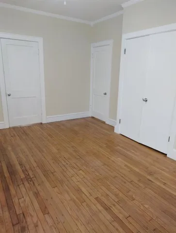 a view of an empty room and wooden floor