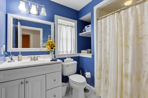 a bathroom with a toilet sink and mirror