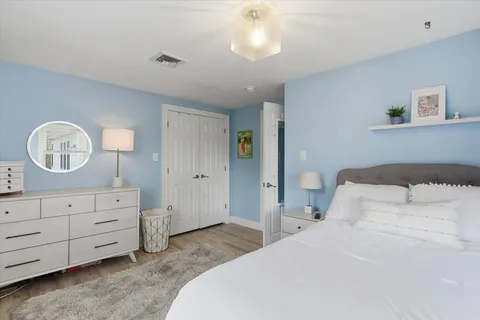 a bedroom with a bed and a dresser