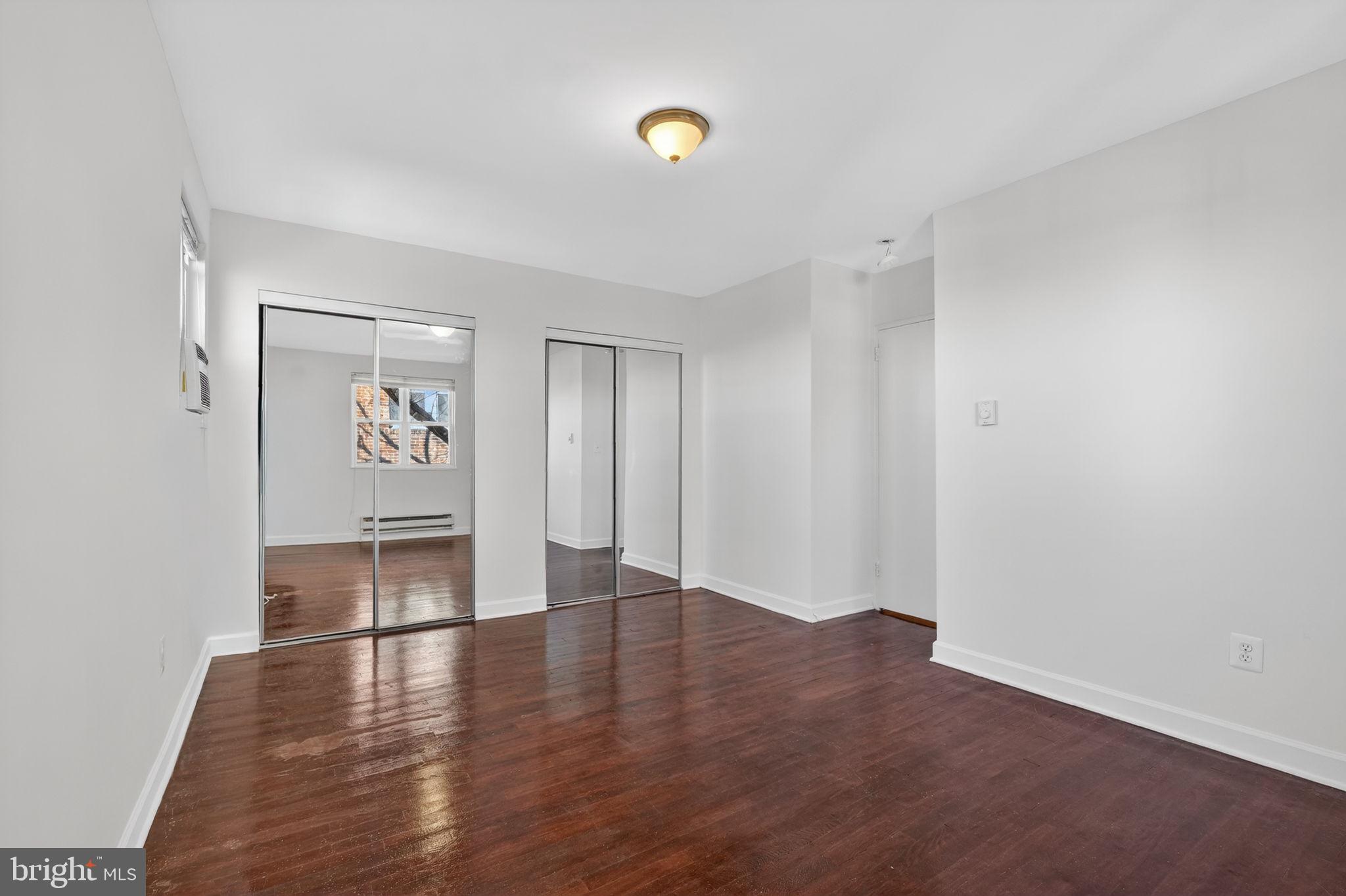 2523 13th Street Northwest, Unit 305 Washington, DC 20009 - Photo 22 of 25 a view of an empty room with window and wooden floor