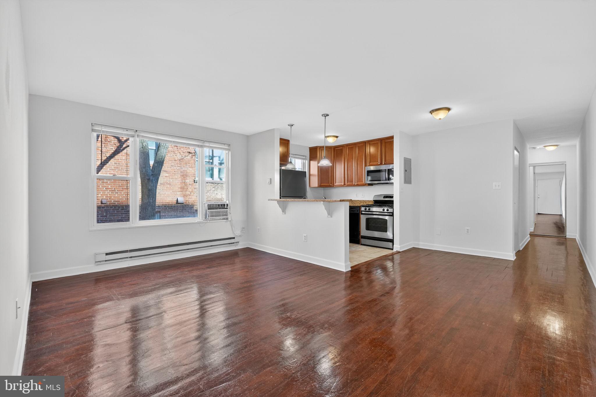 2523 13th Street Northwest, Unit 305 Washington, DC 20009 - Photo 6 of 25 a view of empty room with wooden floor and windows