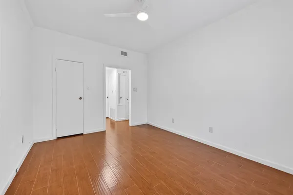 an empty room with wooden floor