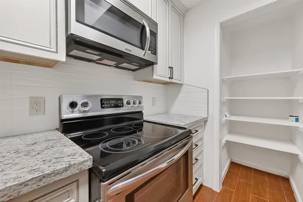 a kitchen with a stove and a microwave