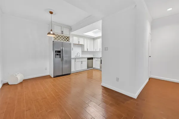 a view of a kitchen with a sink and a refrigerator