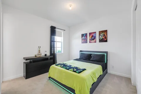 a bedroom with a bed and a desk