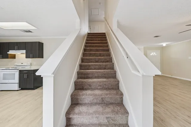 a view of entryway and hall with wooden floor
