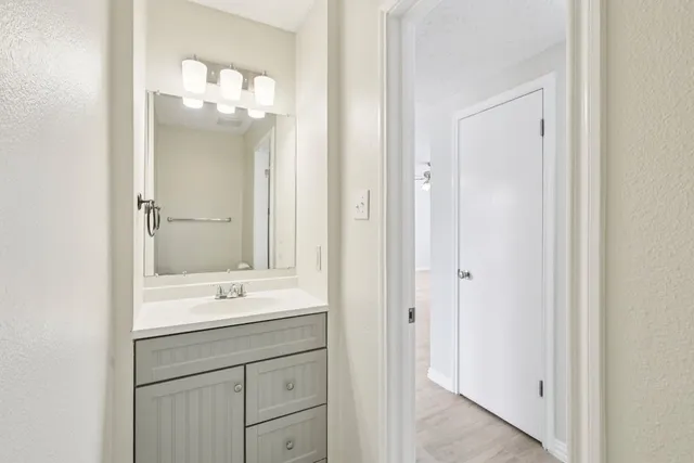 a bathroom with a sink vanity and a mirror