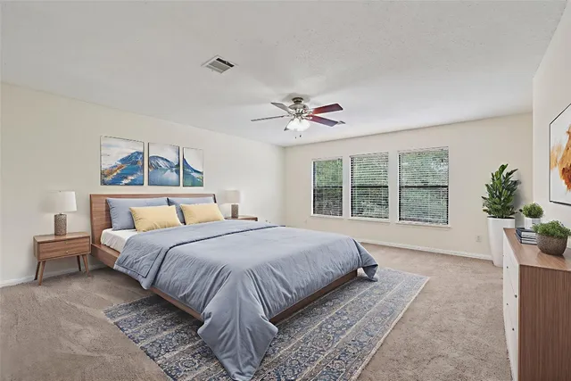 a bedroom with a large bed and a large window