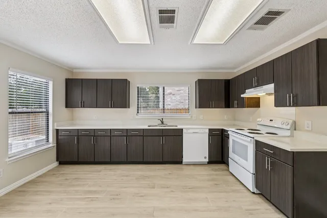 a large kitchen with a stove top oven