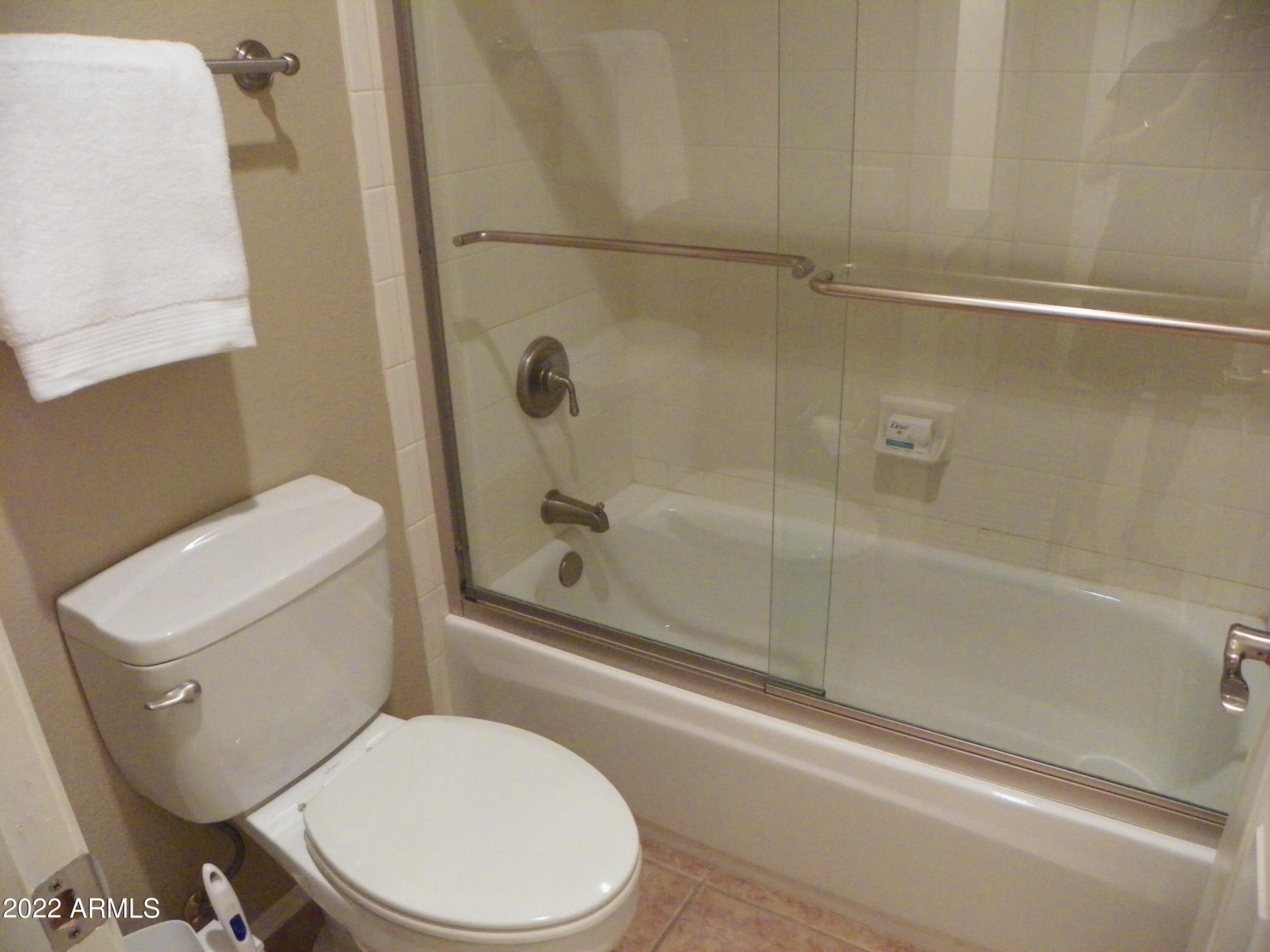 8653 East Royal Palm Road, Unit 1002 Scottsdale, AZ 85258 - Photo 19 of 31 a white toilet and tub next to a shower