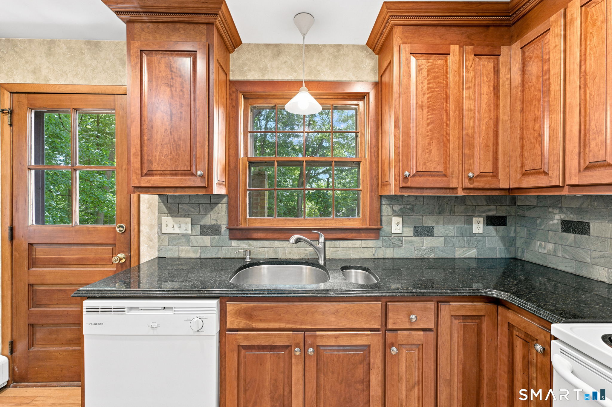 448 Mixville Road Cheshire, CT 06410 - Photo 13 of 32 a kitchen with granite countertop a sink window and cabinets
