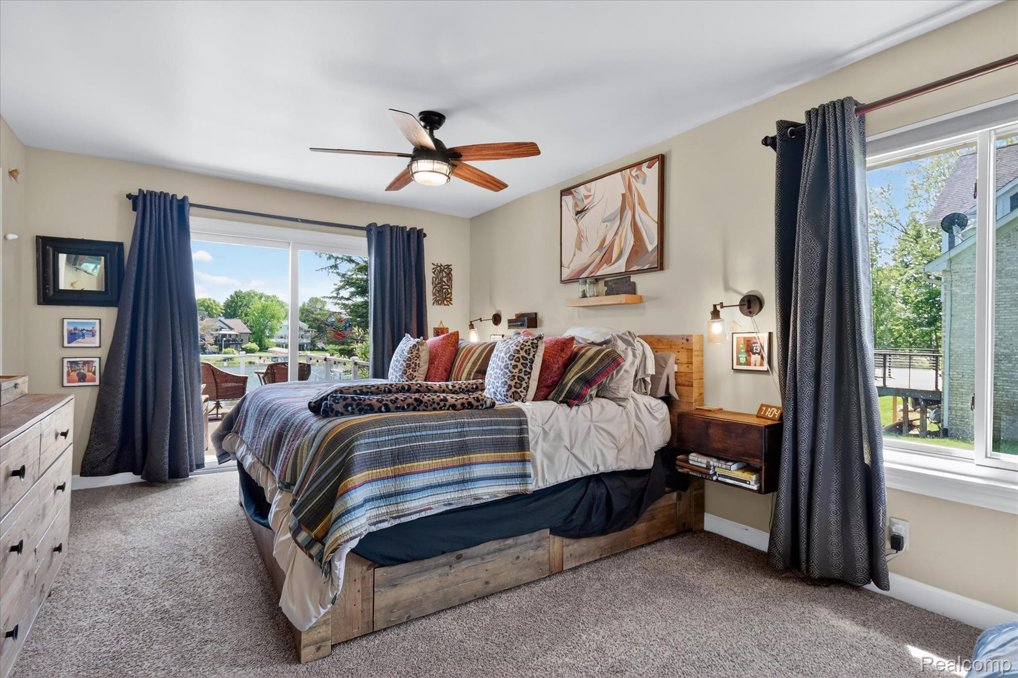 3860 East Commerce Road Commerce Township, MI 48382 - Photo 27 of 72 Carpeted room featuring a ceiling fan with integrated lighting, a large sliding glass door, and an additional window