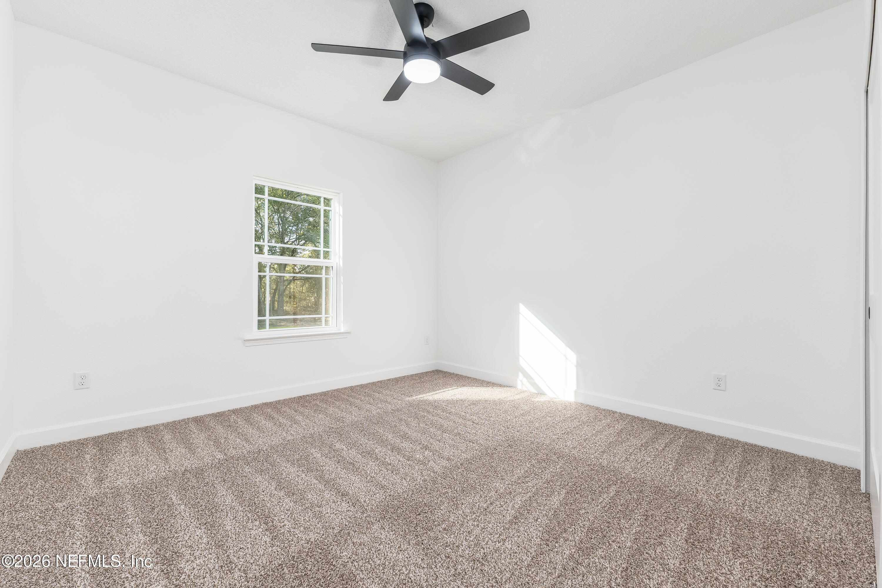 5687 Cibola Street Keystone Heights, FL 32656 - Photo 13 of 21 an empty room with a window and a fan